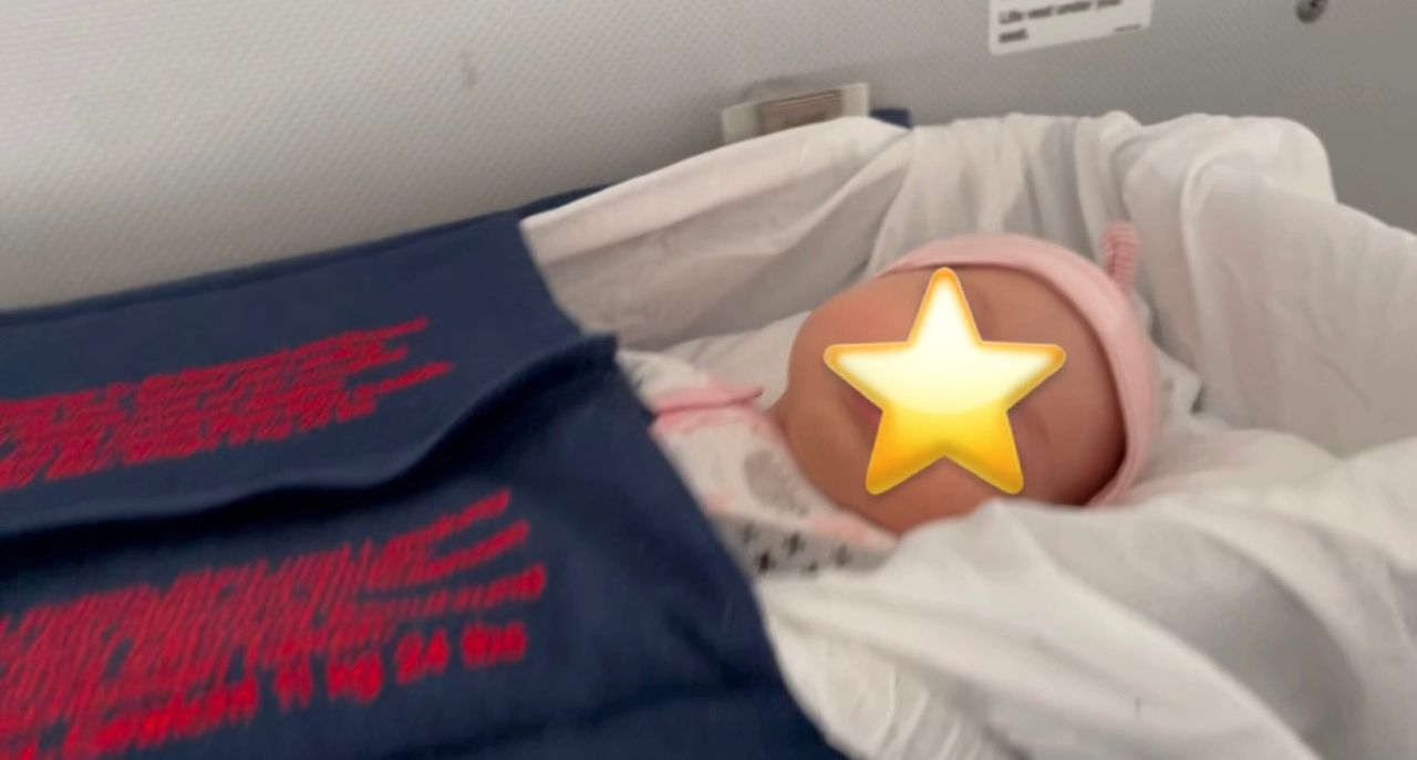 My daughter in a bassinet (United Flight to Switzerland).